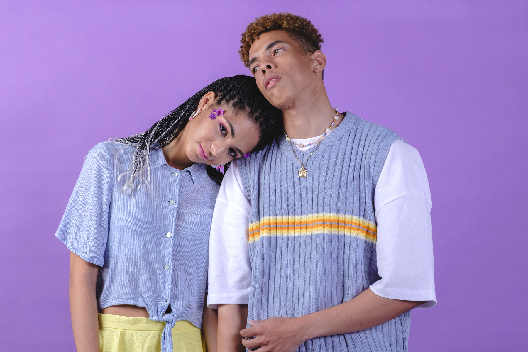 Couple in Matching Purple Shirts on Purple Background